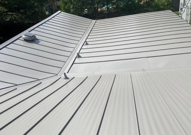 Solar attic fan installed on a metal roof for Roof Ventilation in Cayce